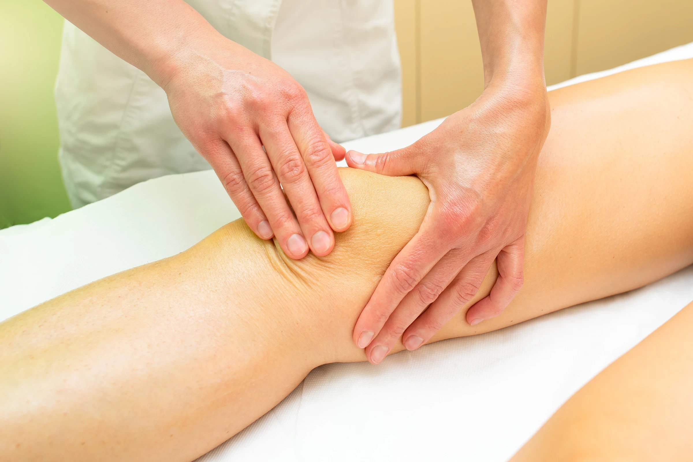 Hands-on joint mobilization technique applied around the client's knee
