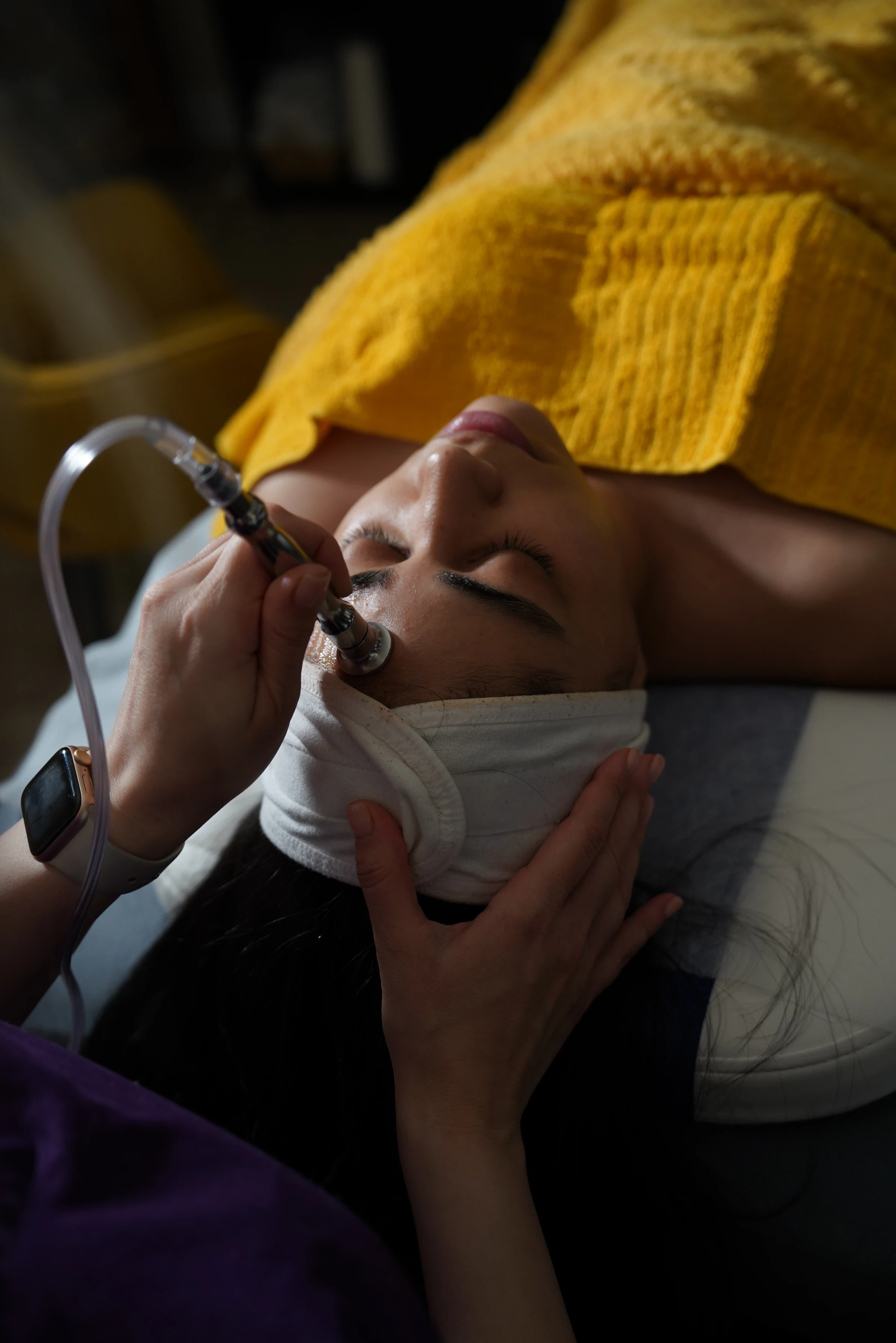 Oxygen infusion treatment applied to the client's face